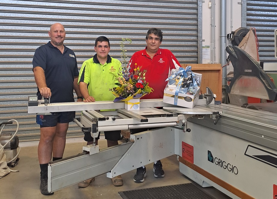Men standing next to Griggio panel saw