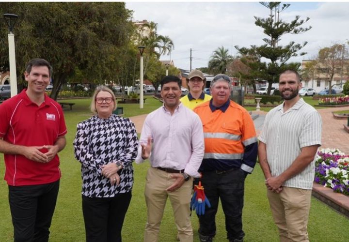 Group of professional and trades people standing on park land